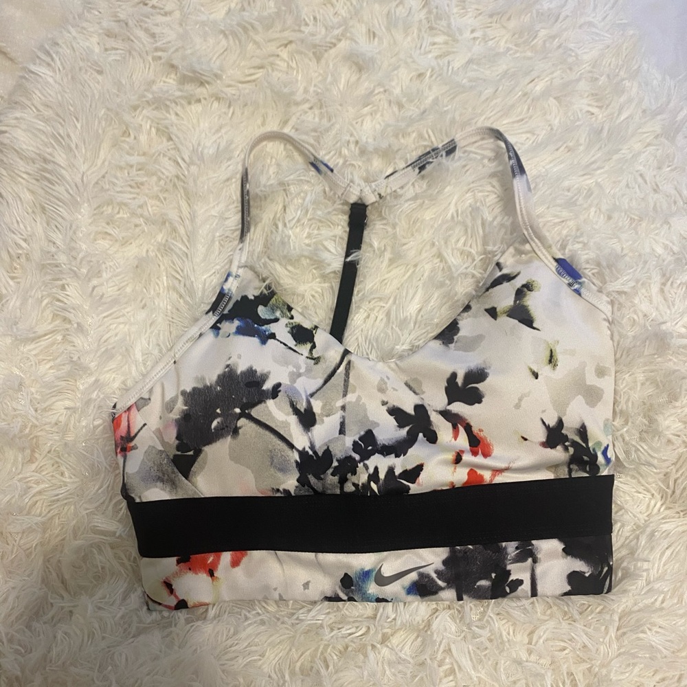 NWOT. Nike sports bra size medium. With a cute open back. Cute flower design.